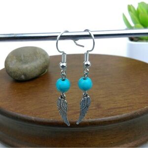 Turquoise & Wing Charm Silver
Tone Earrings